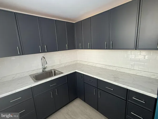a kitchen with a sink and cabinets