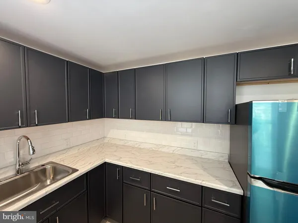 a kitchen with a sink and cabinets