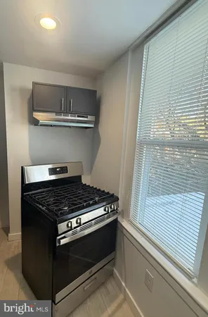 a stove top oven sitting inside of a kitchen