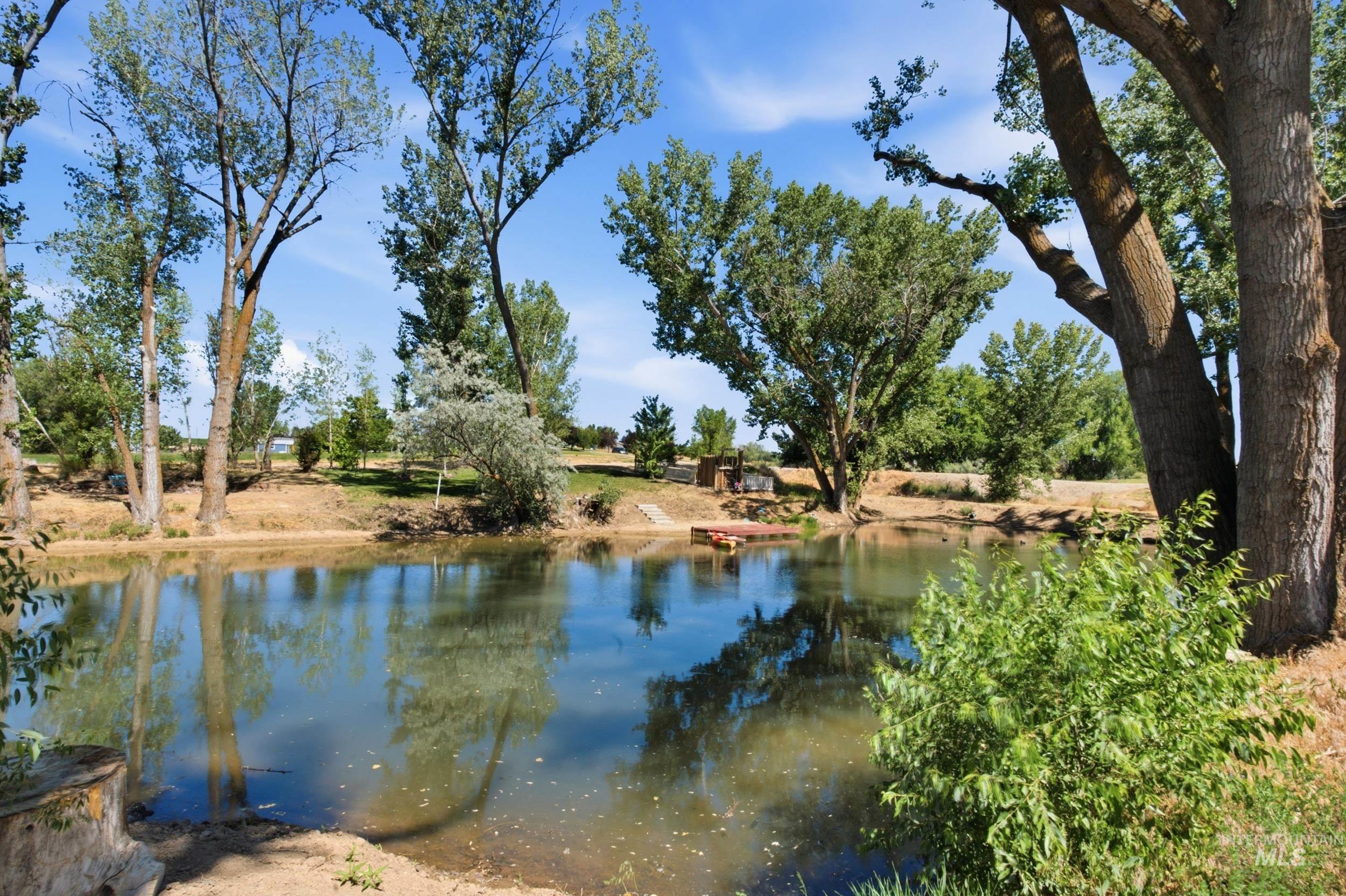 7781 Redmon Road Caldwell, ID 83607 - Photo 6 of 50 Natural pond surrounded by mature deciduous trees and varied vegetation