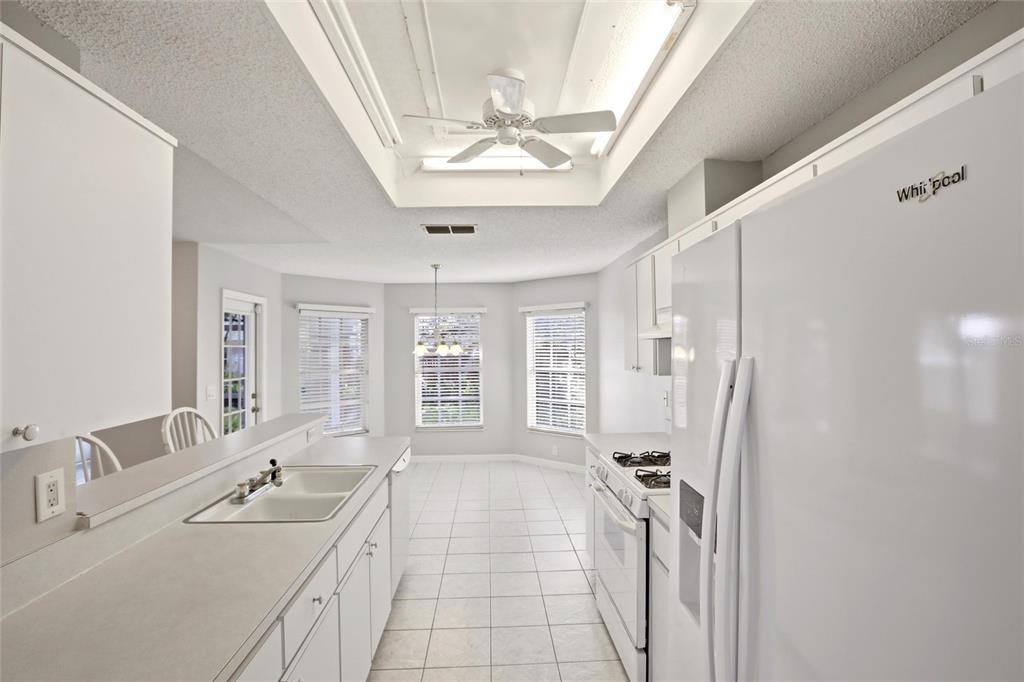 24644 Laurel Ridge Drive Lutz, FL 33559 - Photo 12 of 42 a spacious bathroom with a double vanity sink a mirror a bathtub and next to a window