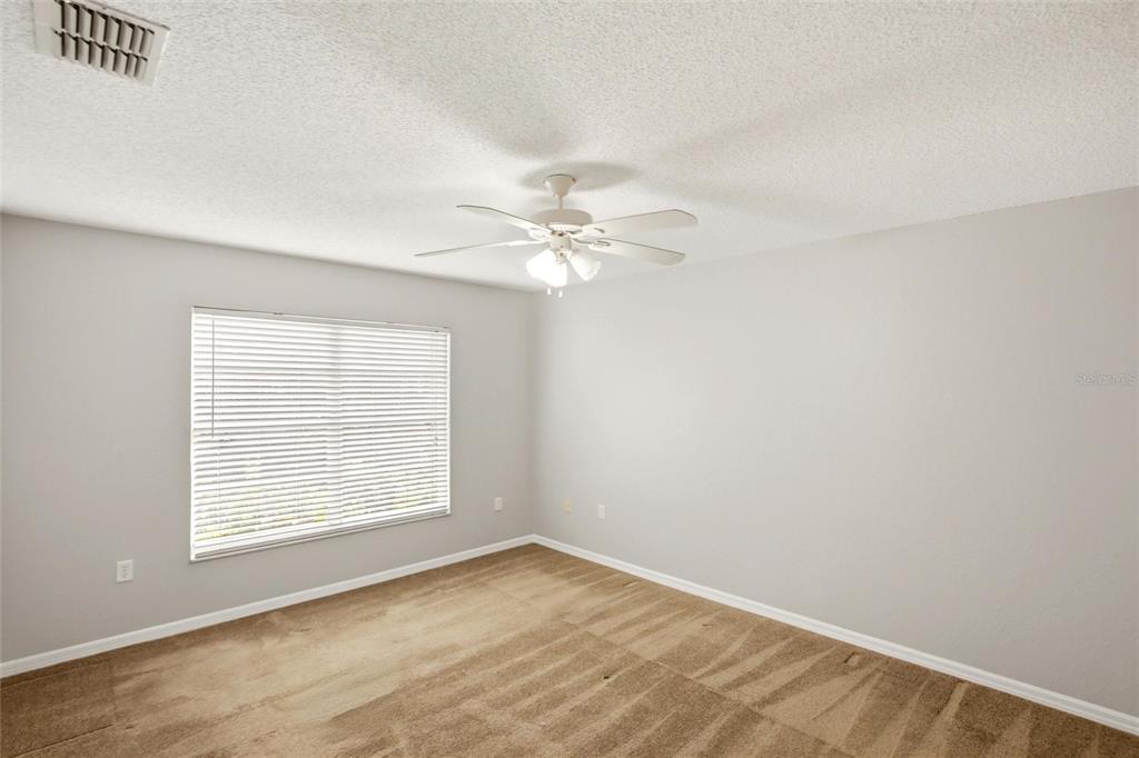 24644 Laurel Ridge Drive Lutz, FL 33559 - Photo 17 of 42 an empty room with a window and a ceiling fan