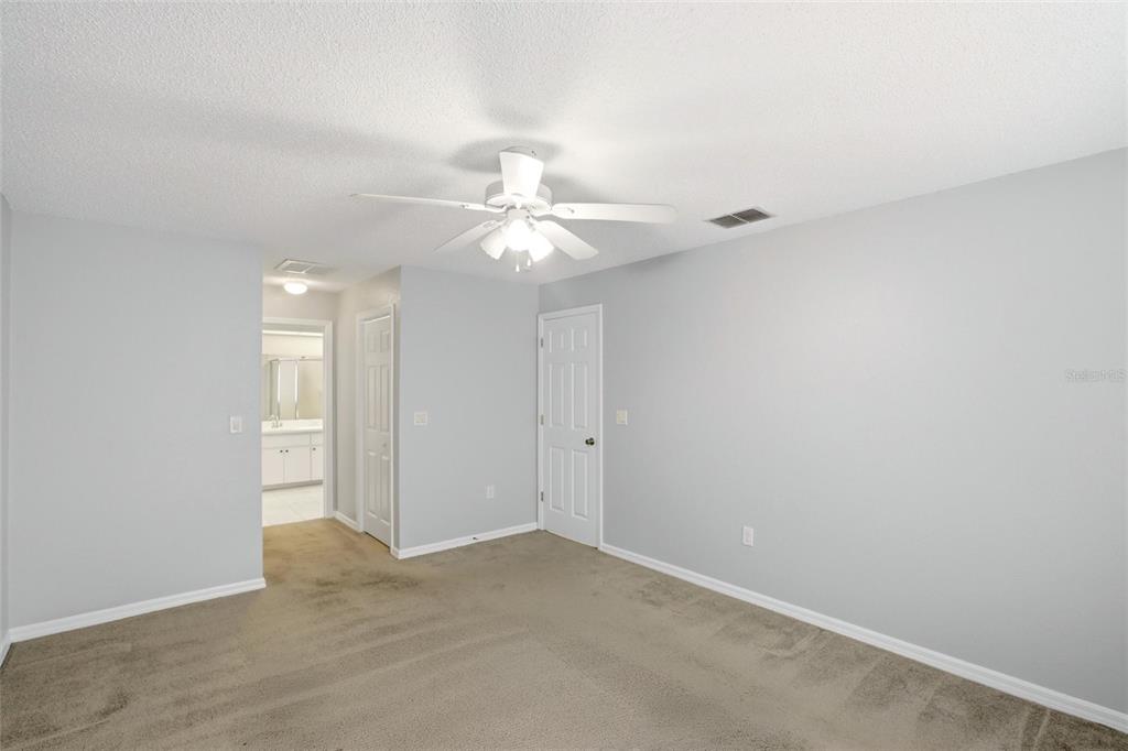 24644 Laurel Ridge Drive Lutz, FL 33559 - Photo 18 of 42 a view of a room with a ceiling fan and a fan