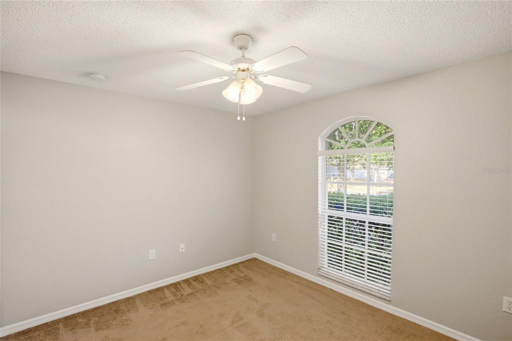 24644 Laurel Ridge Drive Lutz, FL 33559 - Photo 31 of 42 an empty room with windows and fan