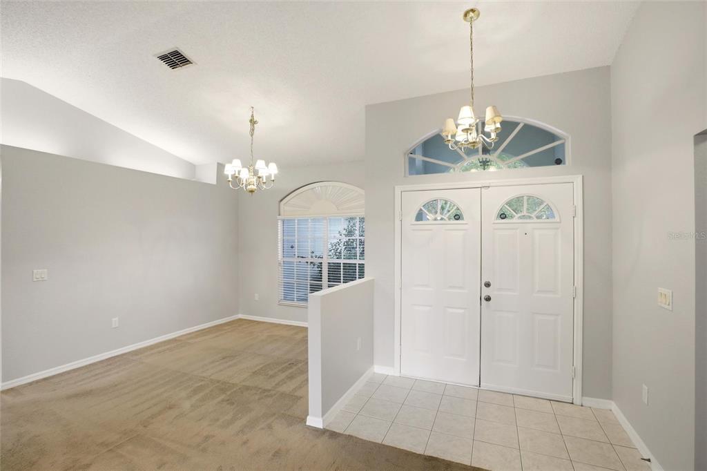 24644 Laurel Ridge Drive Lutz, FL 33559 - Photo 5 of 42 a view of a room with a chandelier and wooden floor