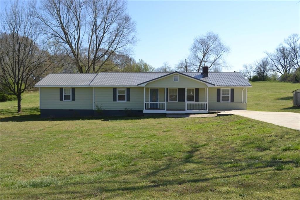13 Howington Road Jefferson, GA 30549 - Photo 1 of 1 a front view of a house with a garden