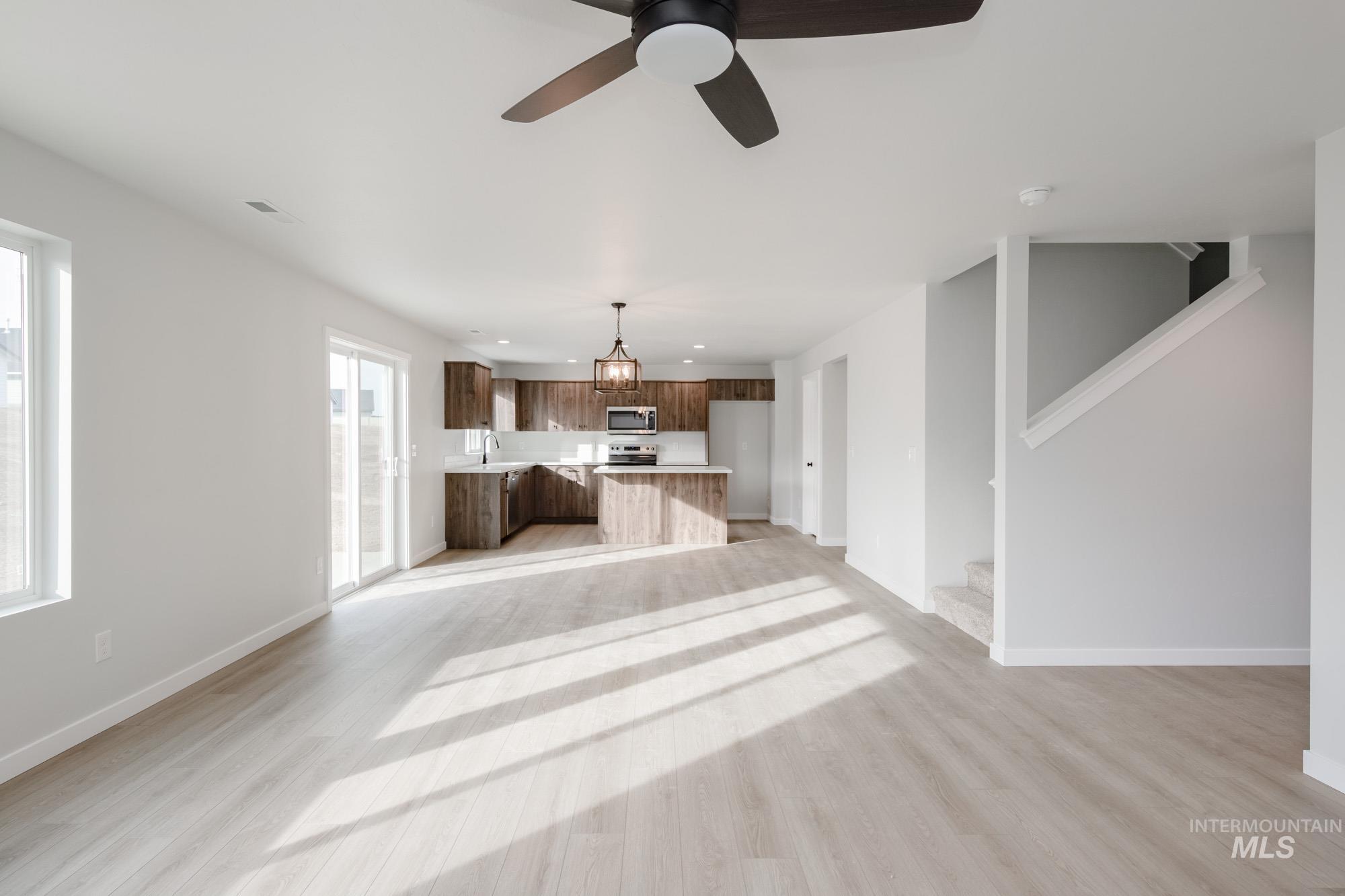 13697 Inman Court Caldwell, ID 83607 - Photo 12 of 23 Unfurnished living room featuring light wood-style flooring, recessed lighting, and a ceiling fan