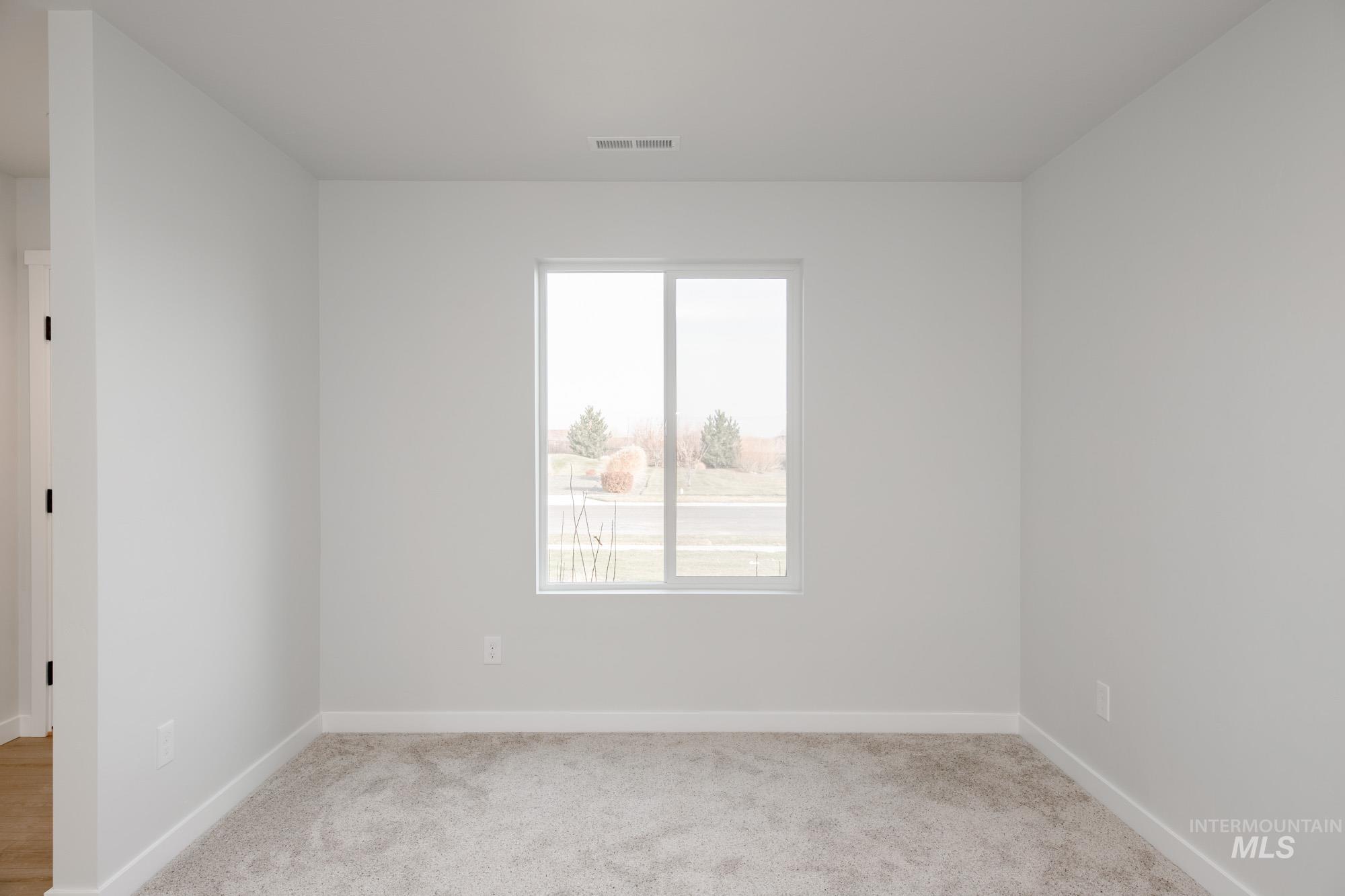 13697 Inman Court Caldwell, ID 83607 - Photo 13 of 23 Empty room with light carpet
