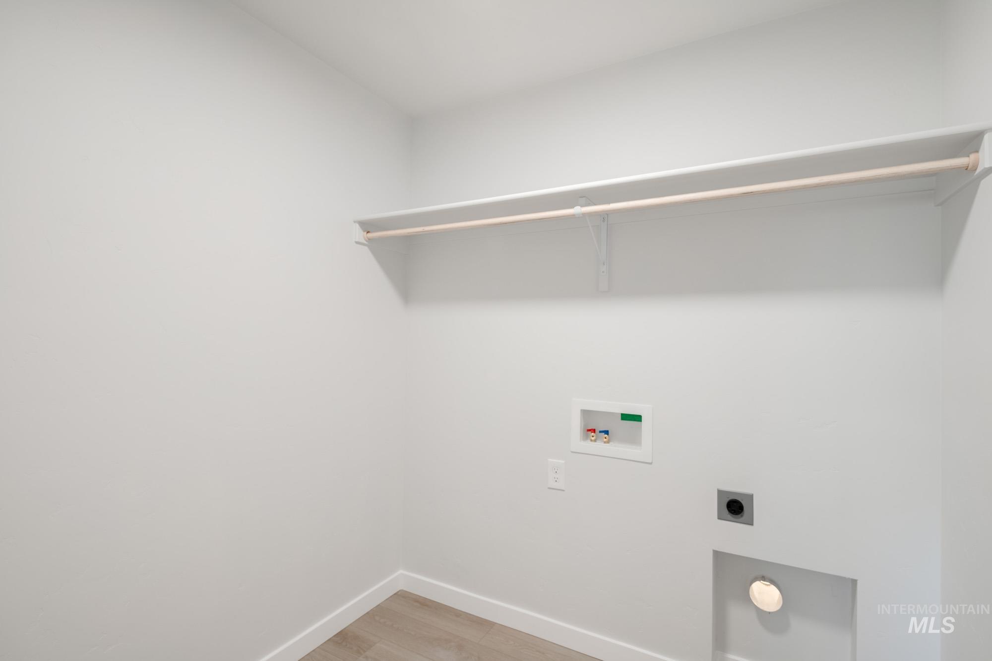 13697 Inman Court Caldwell, ID 83607 - Photo 18 of 23 Laundry room featuring light wood-style floors, electric dryer hookup, and hookup for a washing machine