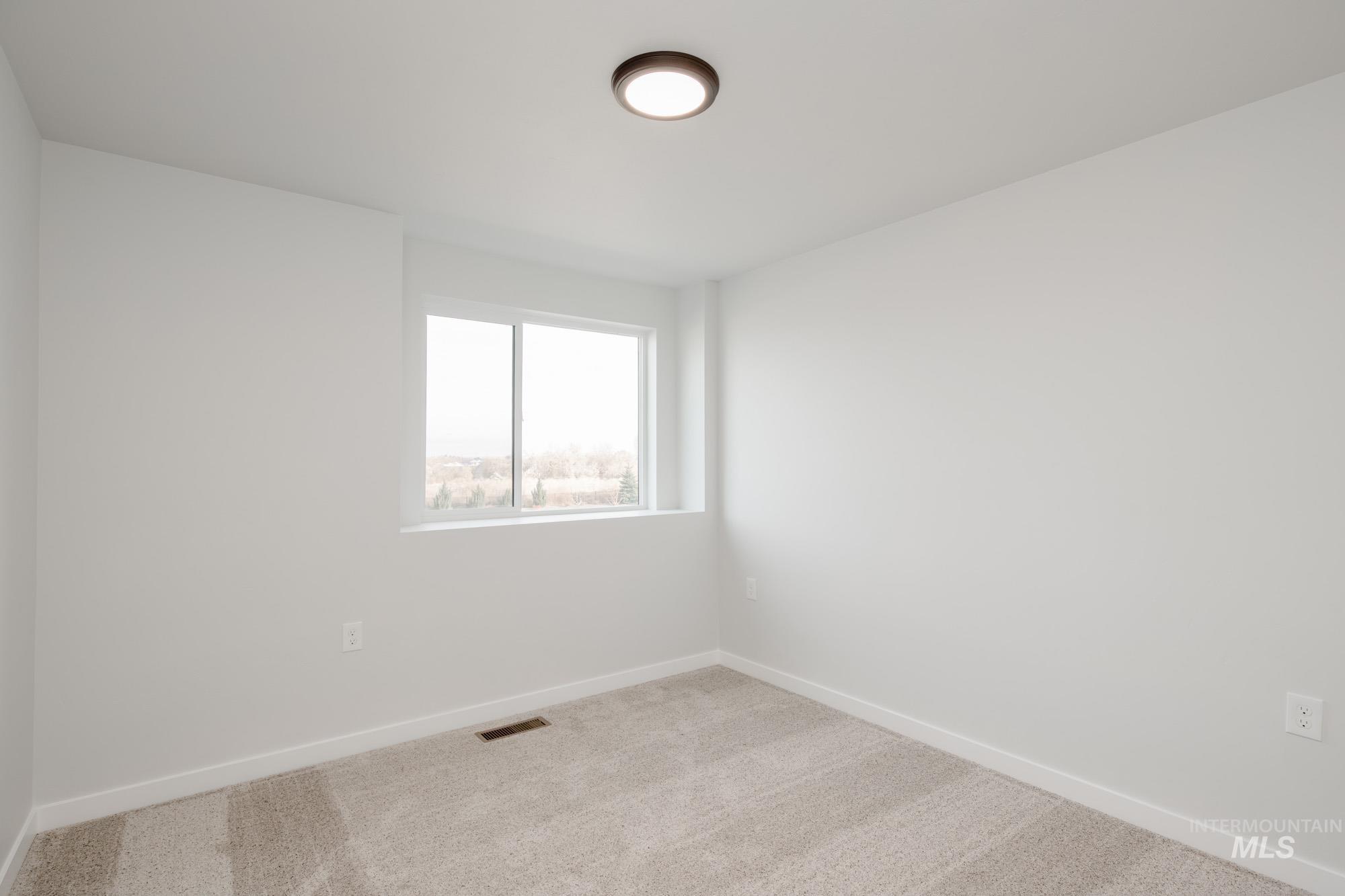 13697 Inman Court Caldwell, ID 83607 - Photo 21 of 23 Spare room featuring carpet and baseboards