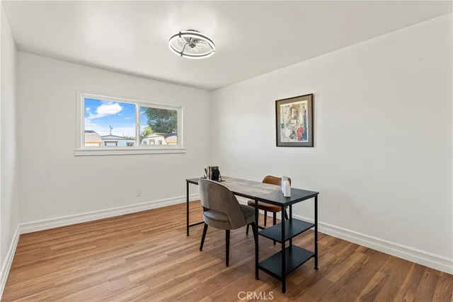 a view of a workspace with wooden floor