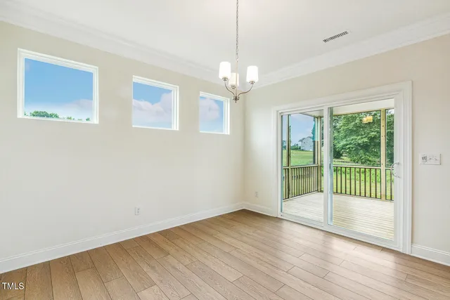 an empty room with a window and a ceiling fan