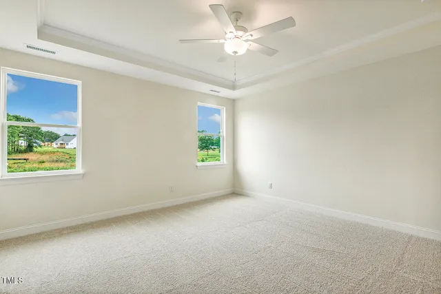 a view of an empty room with a ceiling fan