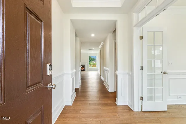 a view of a hallway with wooden floor and staircase