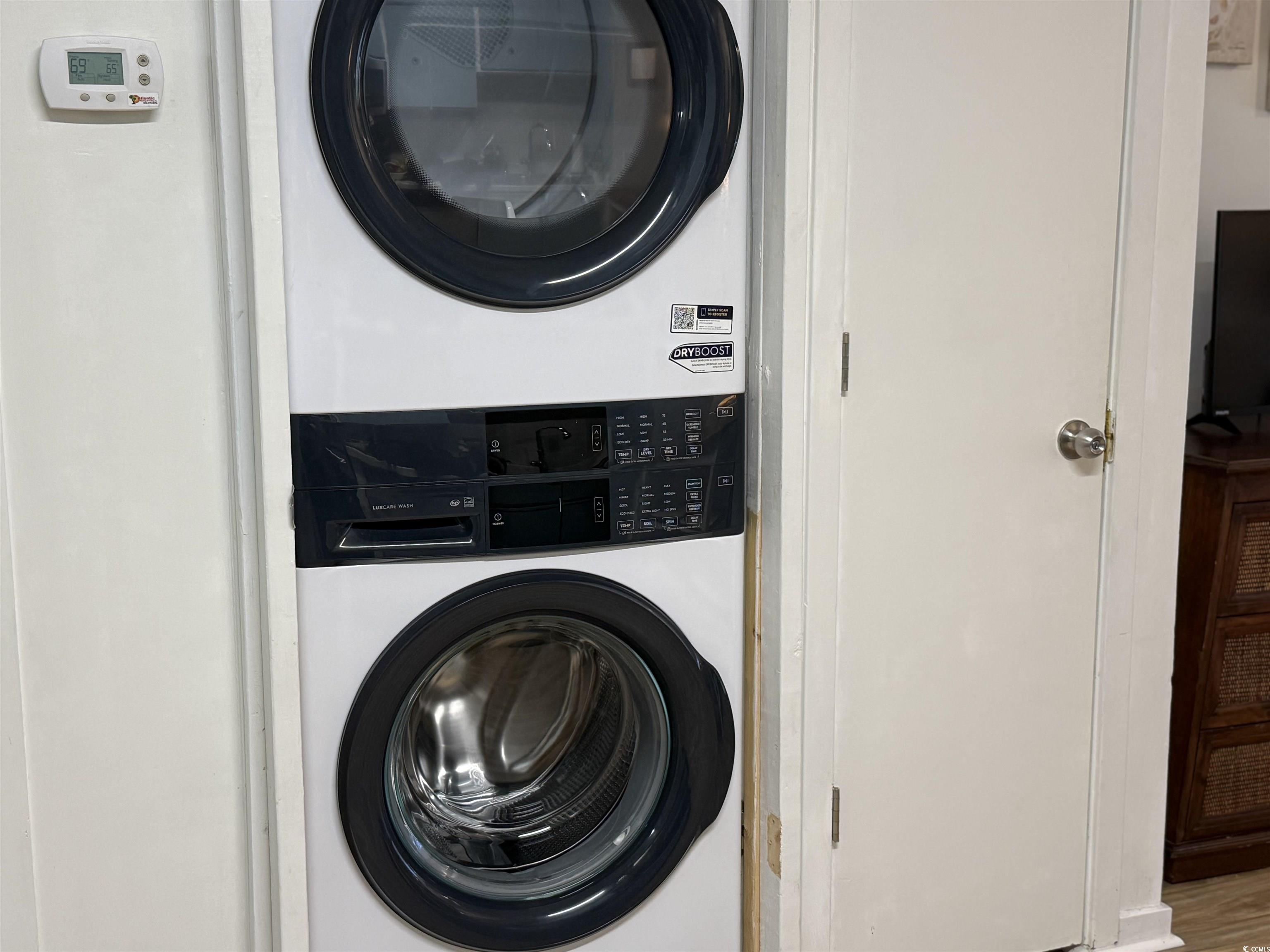 4350 Intercoastal Drive, Unit INTERCOASTAL VILLAGE UNI Little River, SC 29566 - Photo 18 of 21 Laundry area with stacked washer and clothes dryer