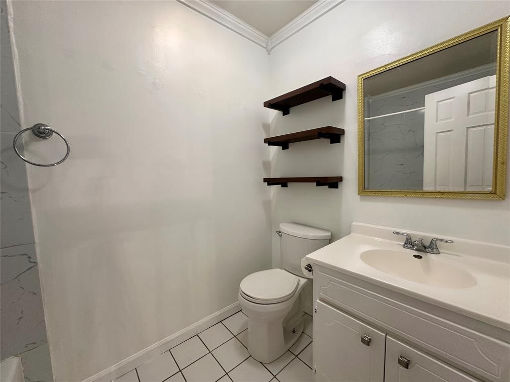 2734 Mildred Street Waco, TX 76706 - Photo 20 of 32 Upstairs bathroom with vanity, crown molding, light tile patterned floors, and a shower