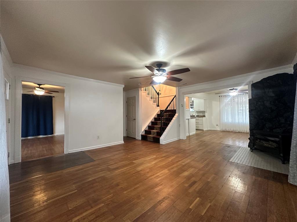 2734 Mildred Street Waco, TX 76706 - Photo 4 of 32 Living room featuring ceiling fan, dark wood finished floors, and ornamental molding