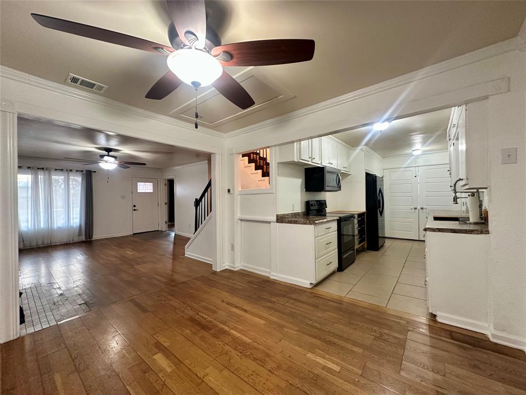2734 Mildred Street Waco, TX 76706 - Photo 6 of 32 Dining room featuring white cabinetry, black appliances, light wood-type flooring, ceiling fan, and ornamental molding