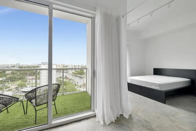 a bedroom with furniture and window