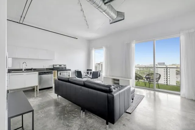a living room with furniture and a large window