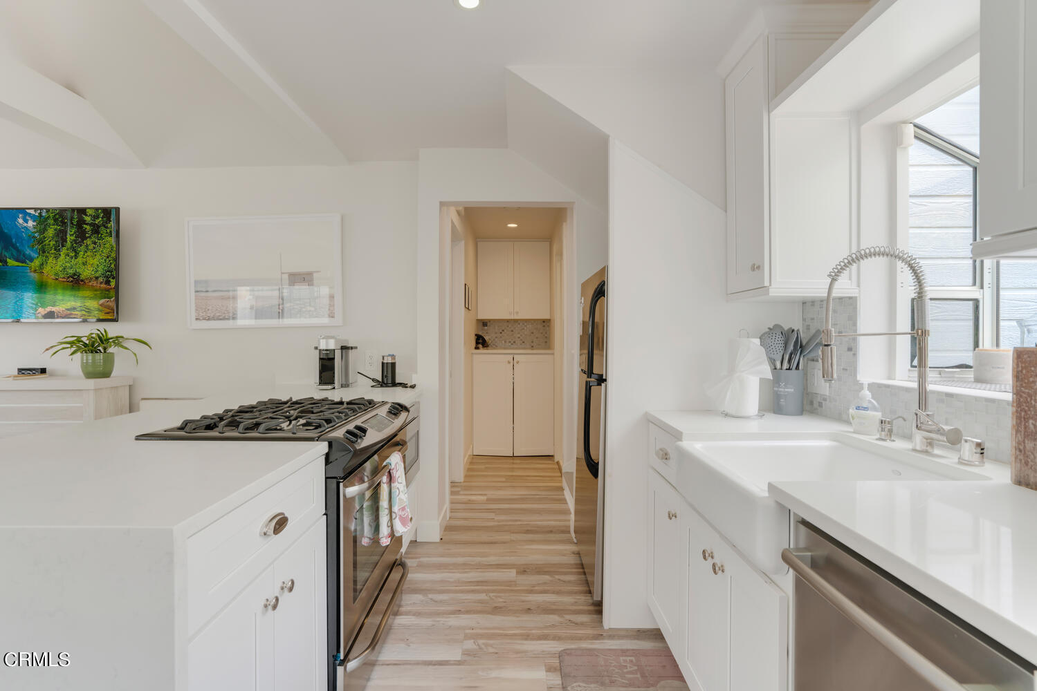 3534 Ocean Drive Oxnard, CA 93035 - Photo 20 of 47 a kitchen with stainless steel appliances granite countertop a sink stove and cabinets