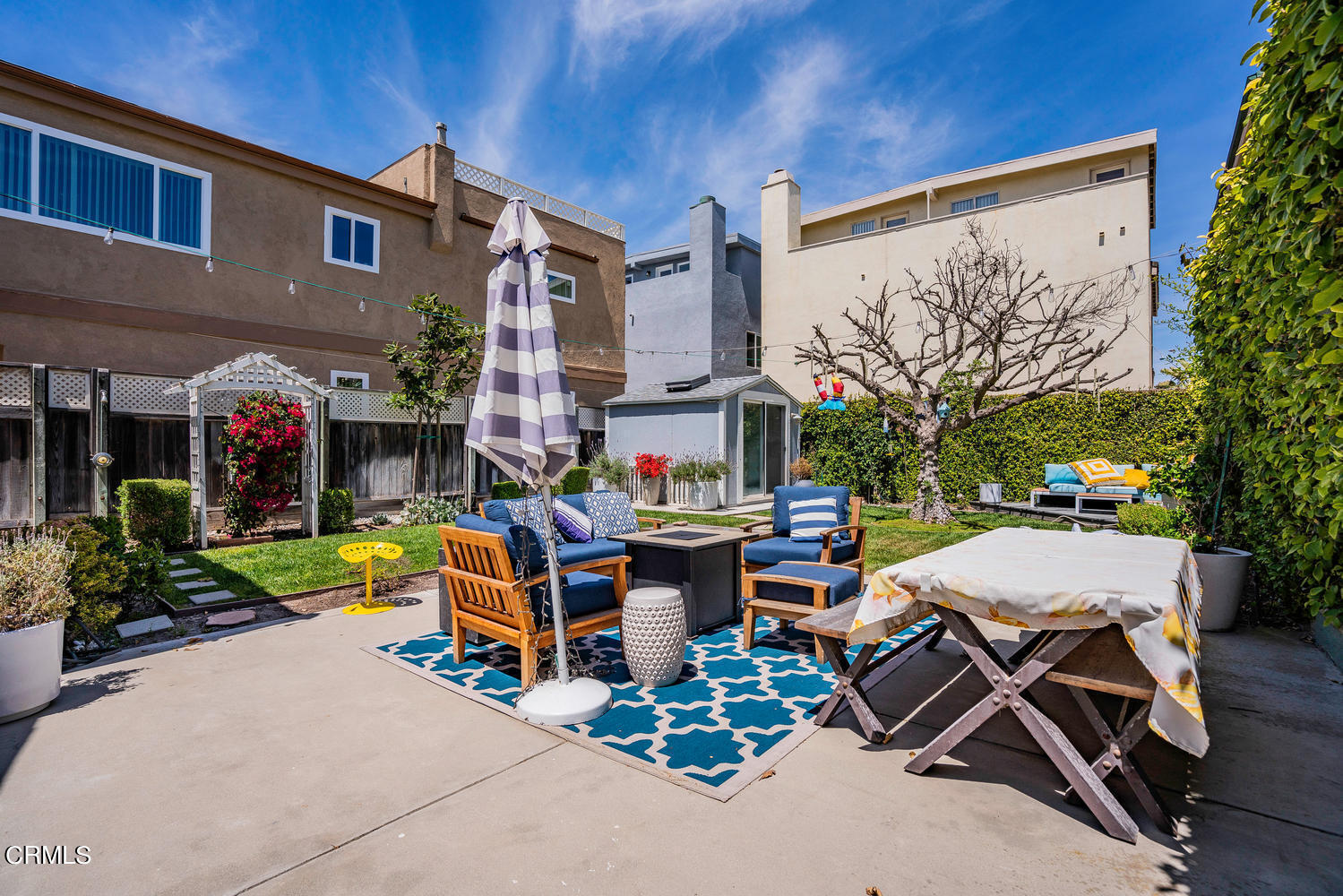3534 Ocean Drive Oxnard, CA 93035 - Photo 27 of 47 a view of a patio with a table and chairs under an umbrella