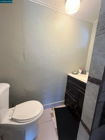a bathroom with a toilet a sink and a mirror
