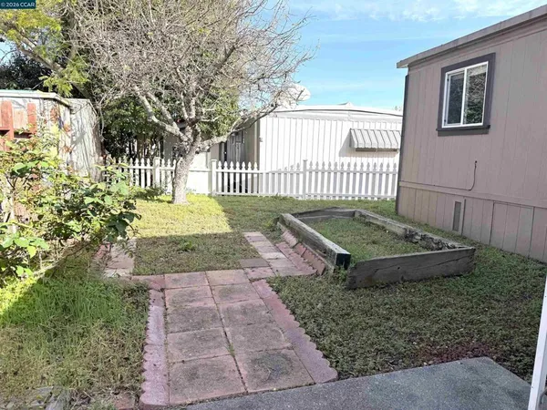 a view of a backyard with a fence