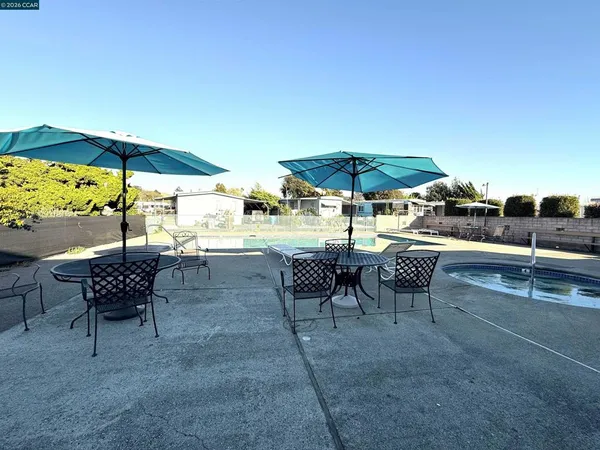 a view of a tables and chairs under an umbrella