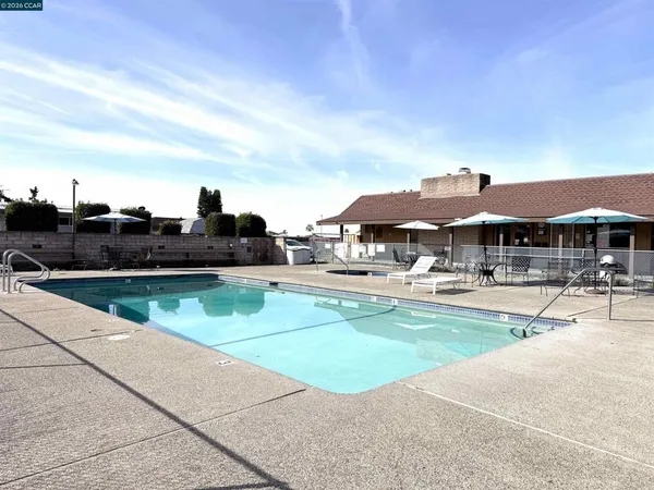a view of pool with outdoor seating
