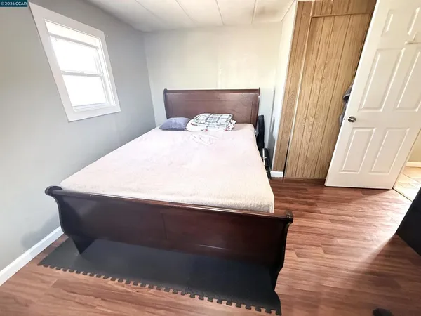 a bed sitting in a bedroom next to a window