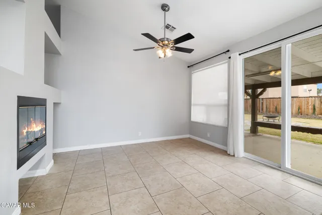 a view of a livingroom with a ceiling fan and window