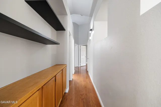a view of a hallway with wooden floor