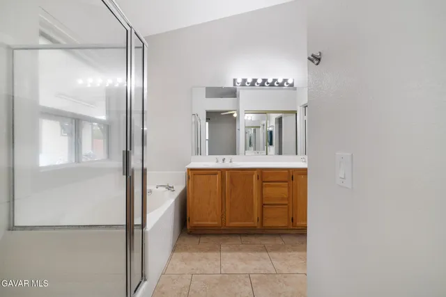 a bathroom with a double vanity sink and a mirror