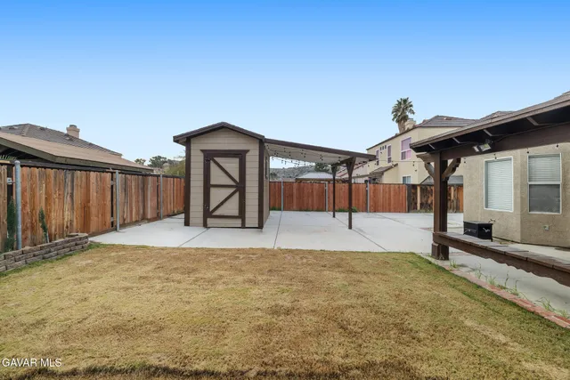 a view of a backyard of the house