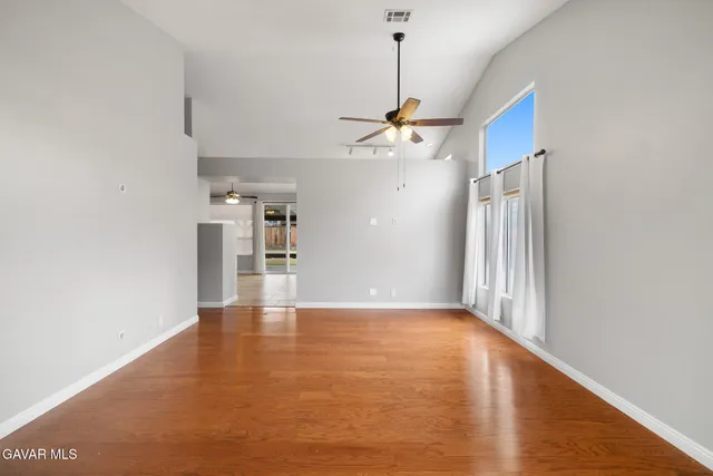 a view of a kitchen with a refrigerator and a window
