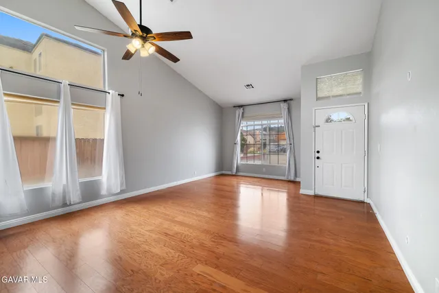 wooden floor in an empty room with a window