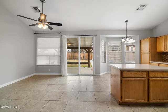 a view of a kitchen with a sink and chandelier