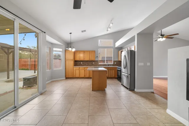 a kitchen with stainless steel appliances granite countertop a refrigerator and a sink