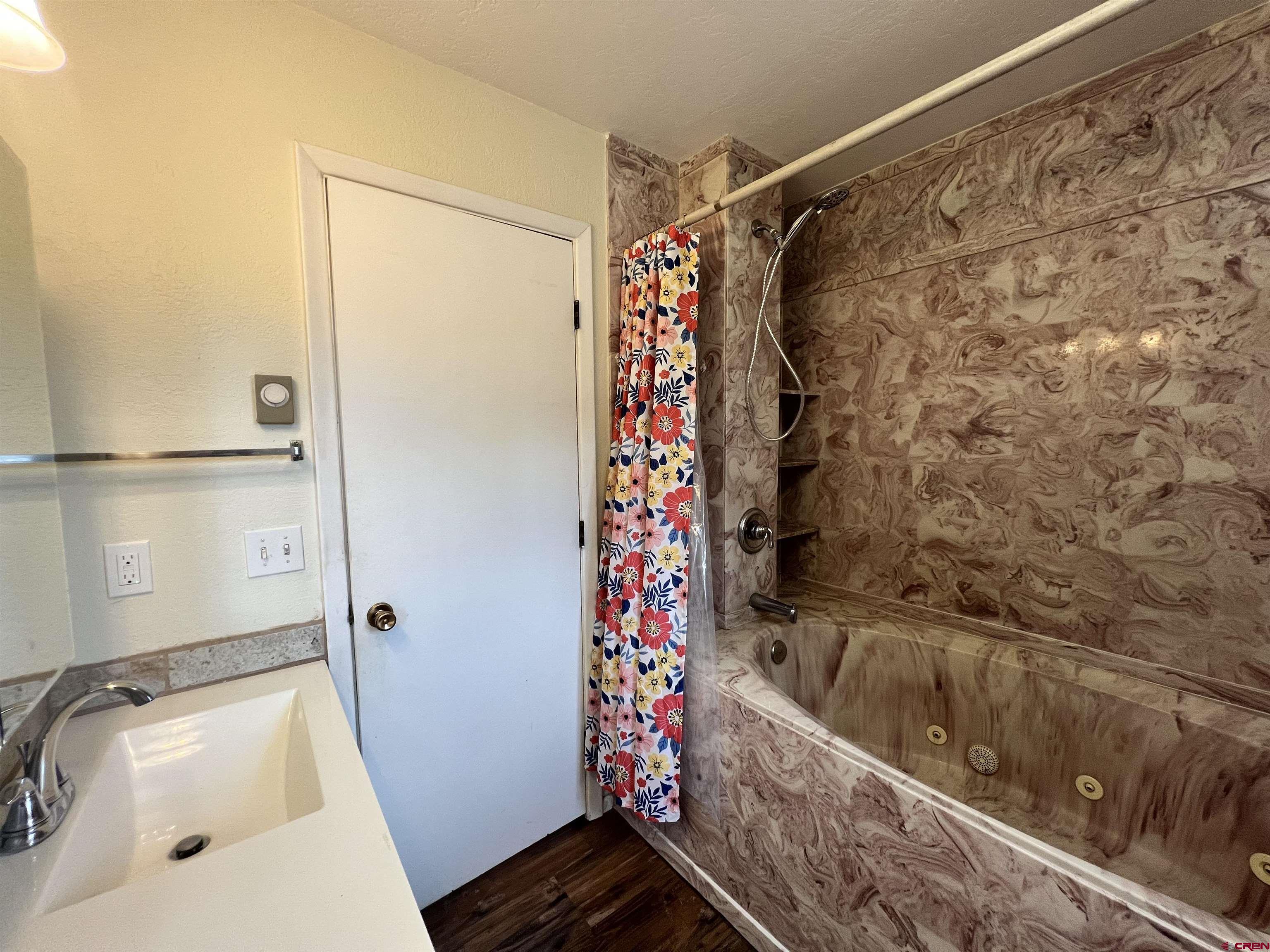 1328 Jackson Street Cortez, CO 81321 - Photo 23 of 37 a bathroom with a bathtub and shower