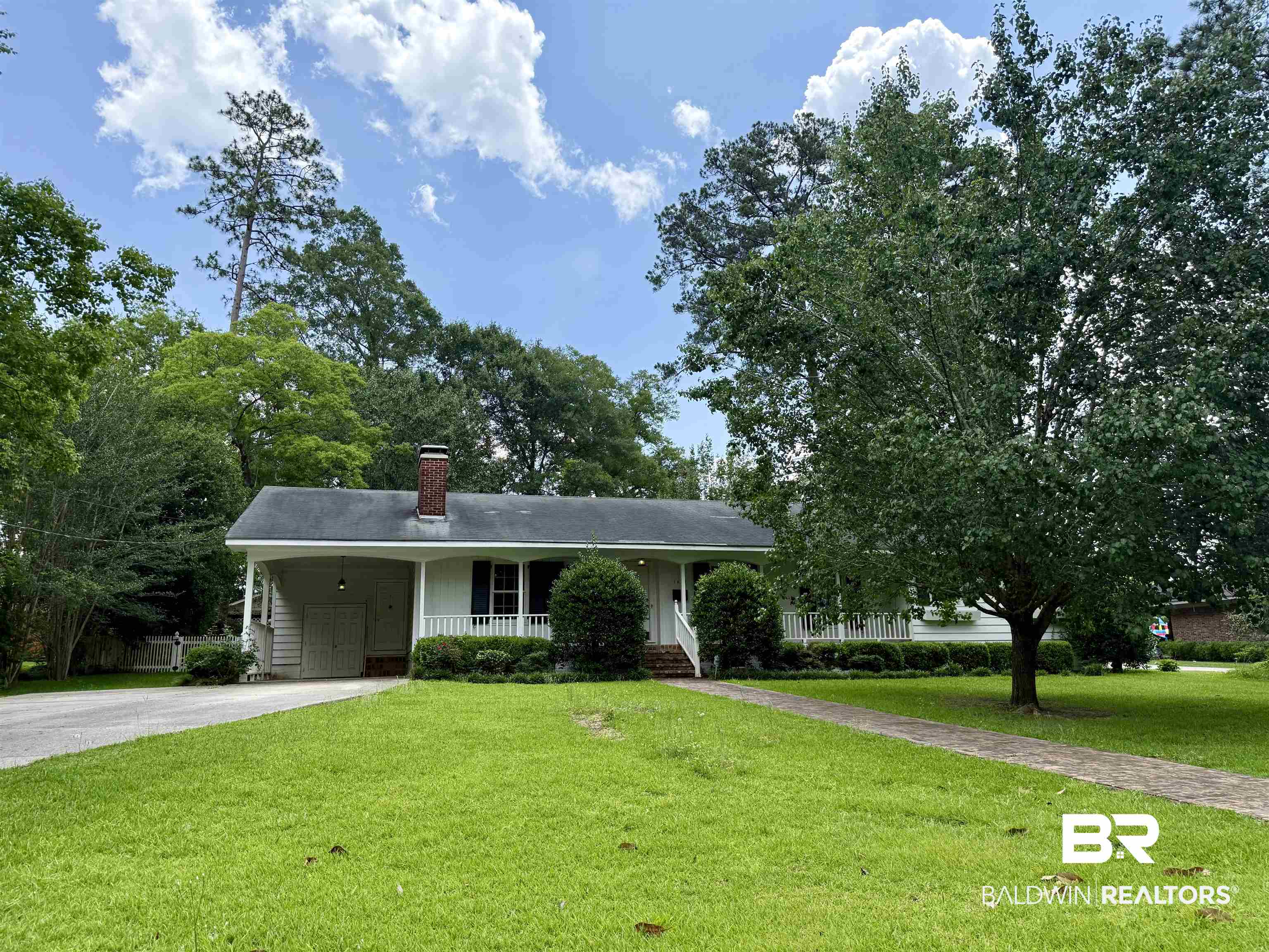 1412 Poplar Avenue Brewton, AL 36426 - Photo 1 of 32 Single story home featuring asphalt driveway, a porch, a chimney, a front lawn, and a carport