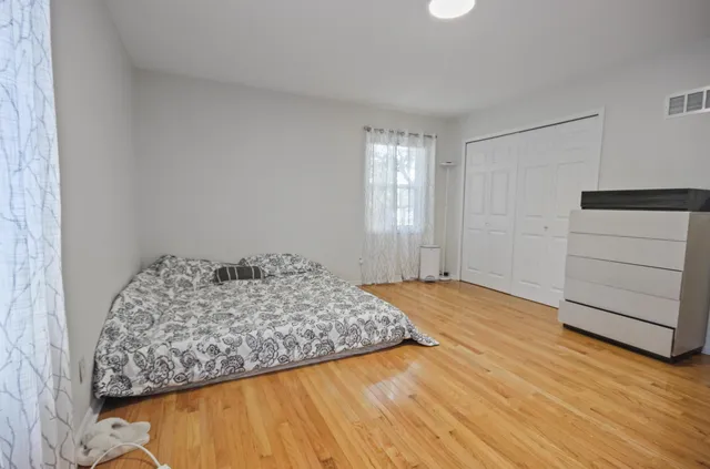 a bedroom with a bed and a dresser