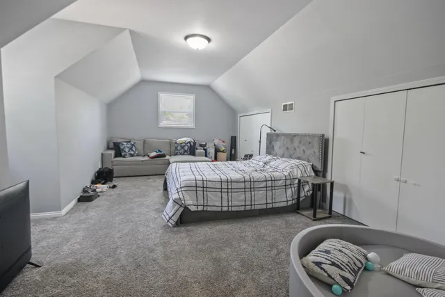 a bedroom with a bed and a couch