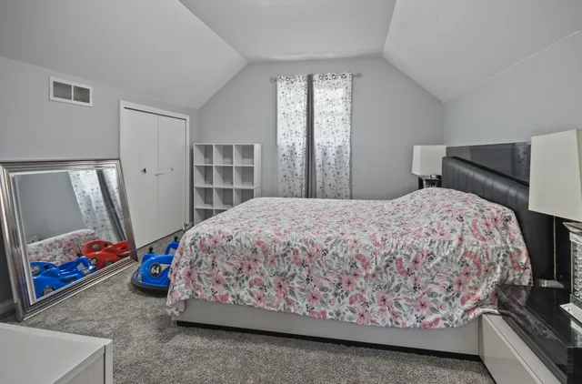 a bed sitting in a bedroom next to a window