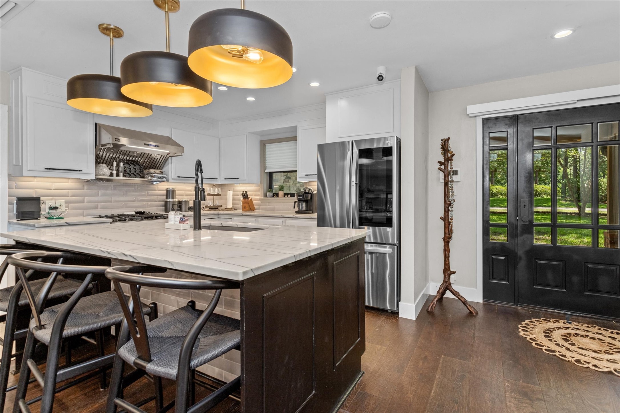 678 Sawmill Road Crockett, TX 75835 - Photo 17 of 29 a kitchen with stainless steel appliances granite countertop a table chairs in it and wooden floors
