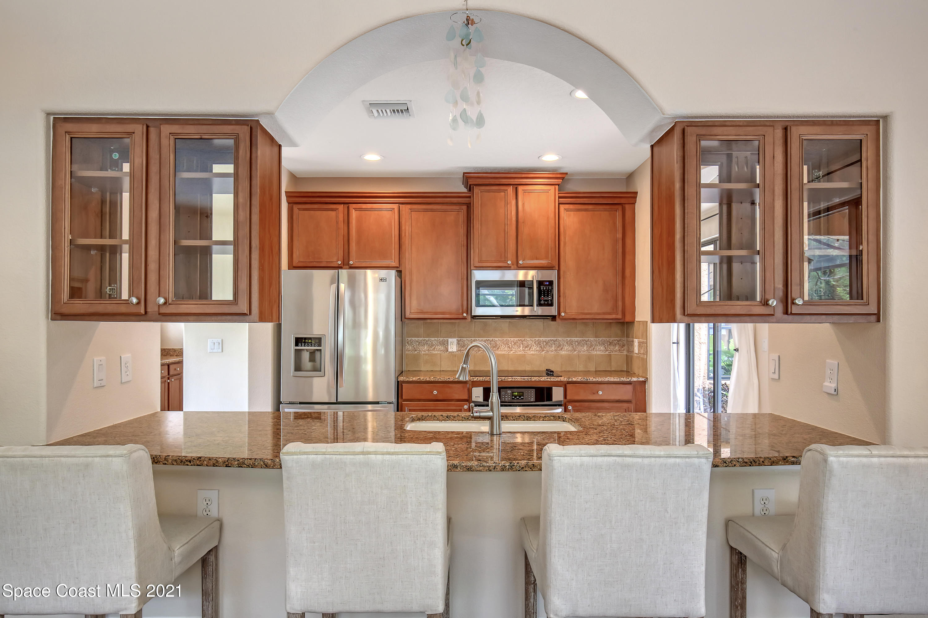 1380 Talon Way Melbourne, FL 32934 - Photo 16 of 59 a kitchen with stainless steel appliances granite countertop a refrigerator and a stove top oven