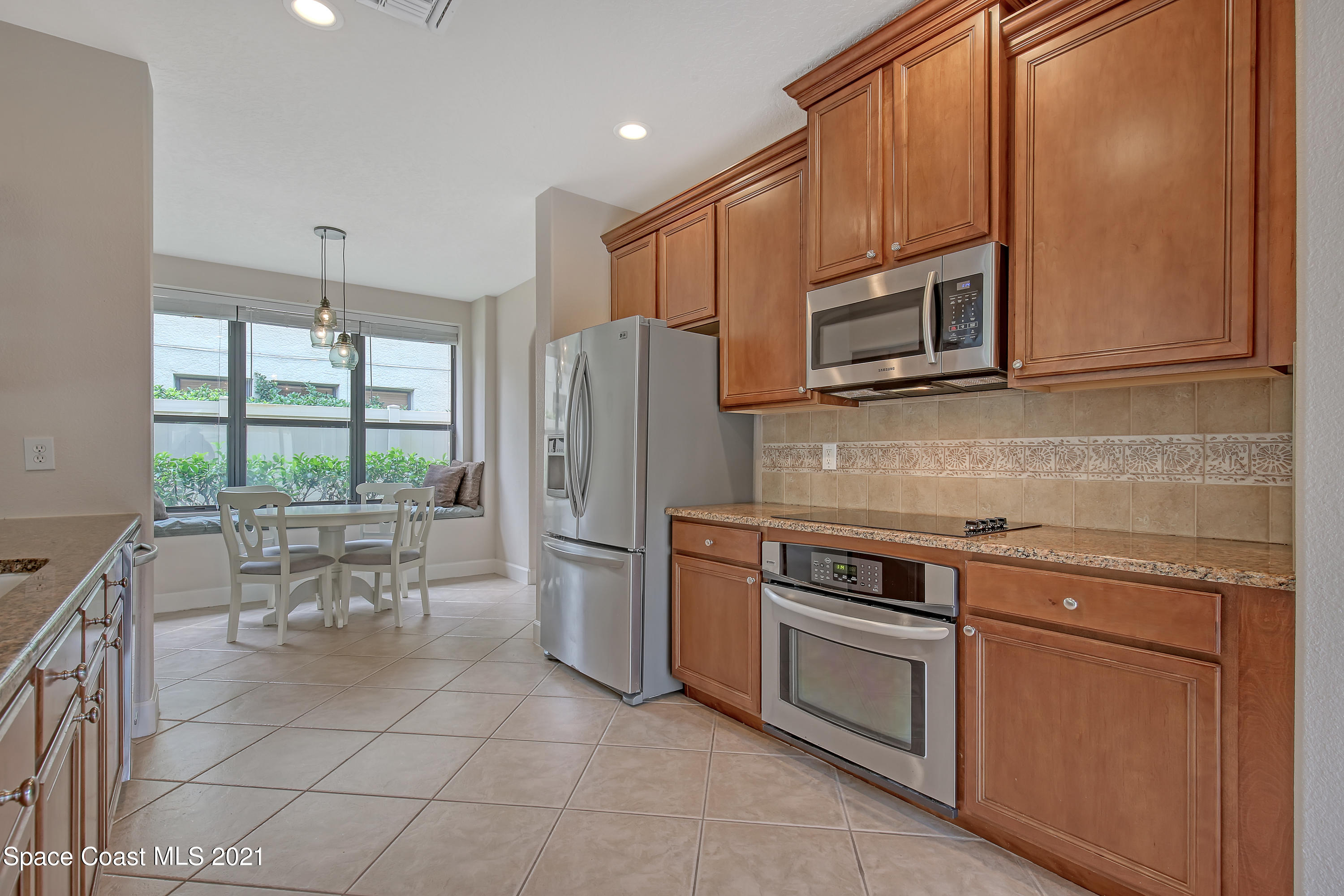 1380 Talon Way Melbourne, FL 32934 - Photo 18 of 59 a kitchen with stainless steel appliances a stove a sink and a refrigerator