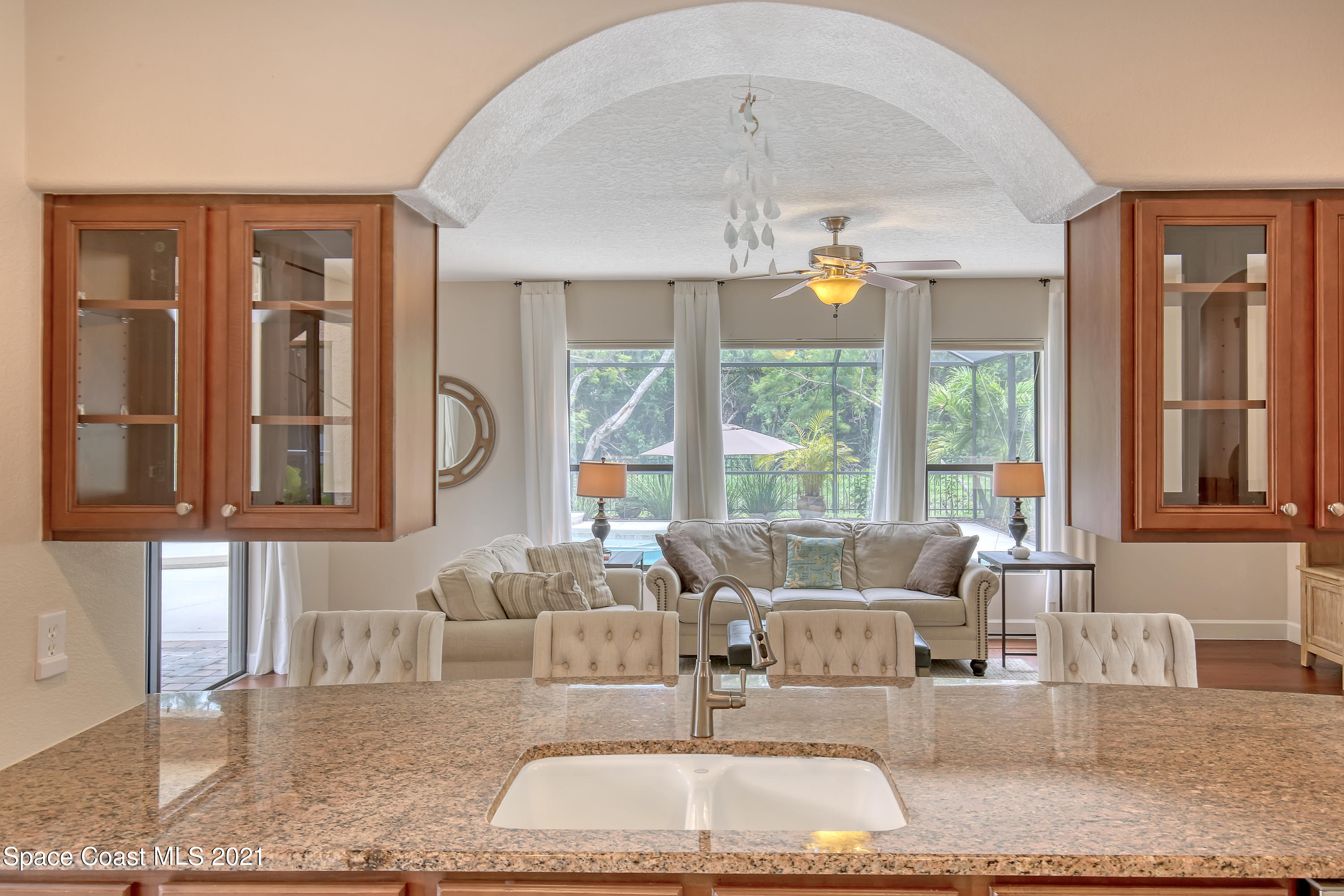 1380 Talon Way Melbourne, FL 32934 - Photo 20 of 59 a living room with furniture and a chandelier