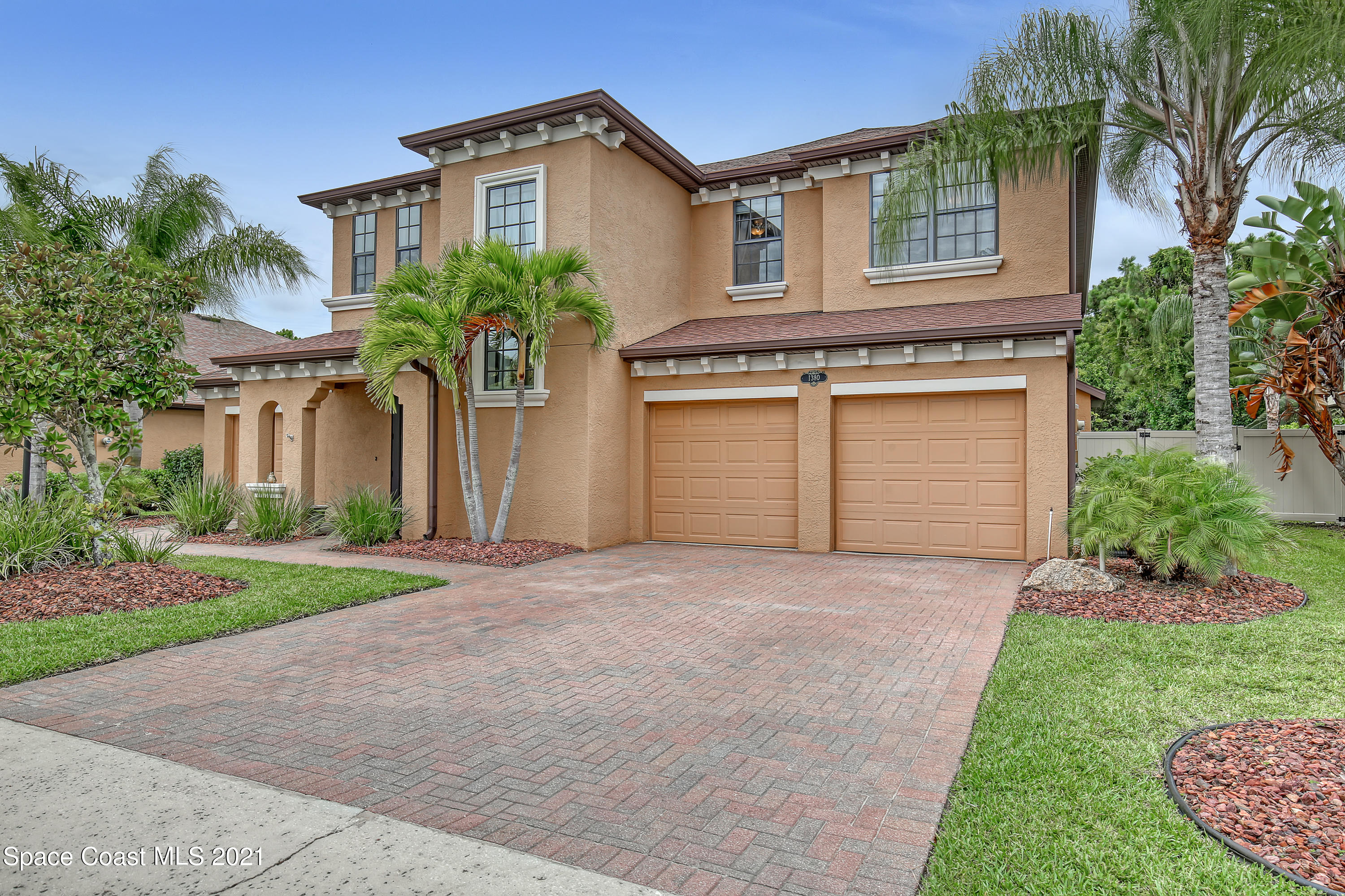 1380 Talon Way Melbourne, FL 32934 - Photo 2 of 59 a front view of a house with a yard and garage