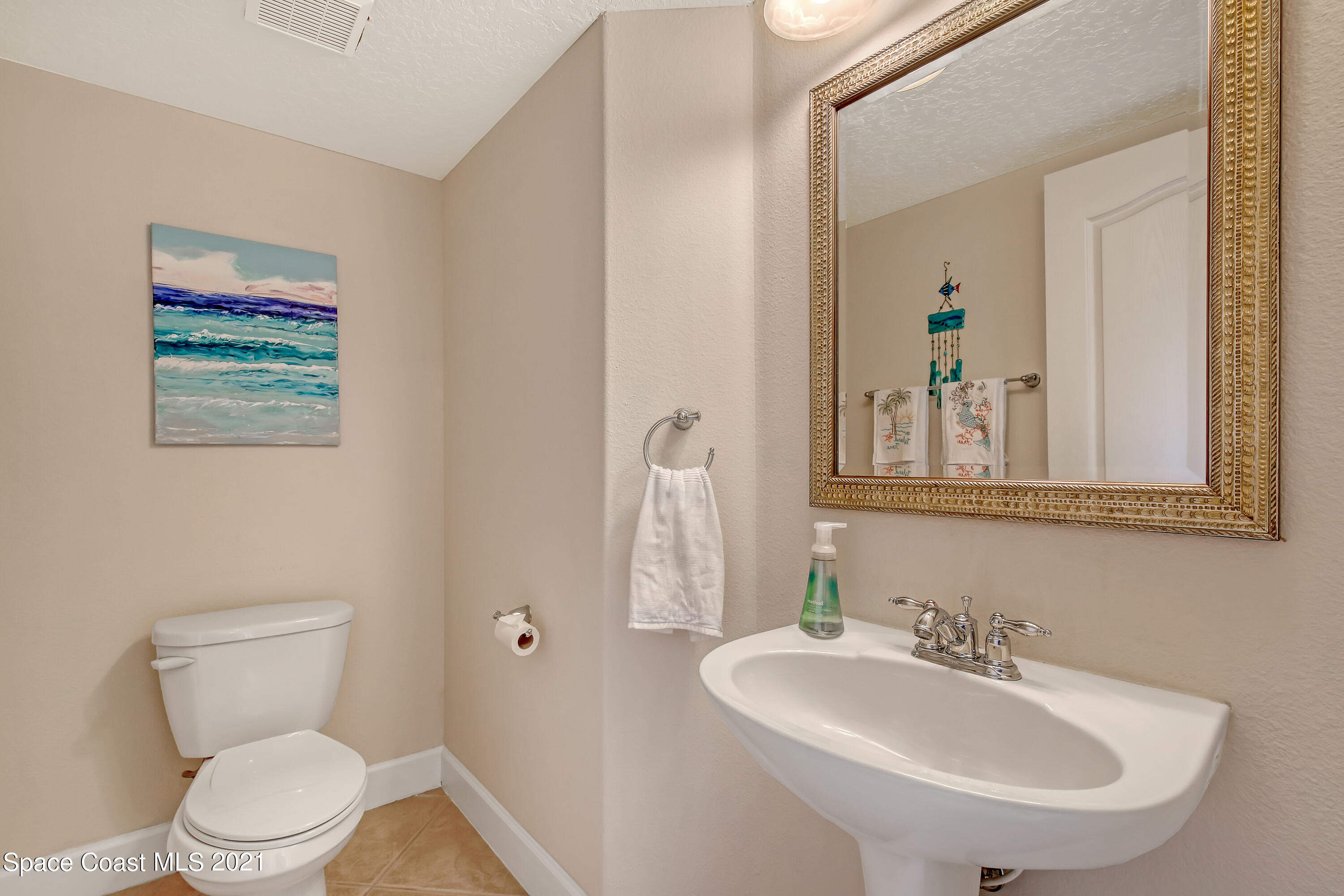 1380 Talon Way Melbourne, FL 32934 - Photo 21 of 59 a bathroom with a toilet a sink and mirror